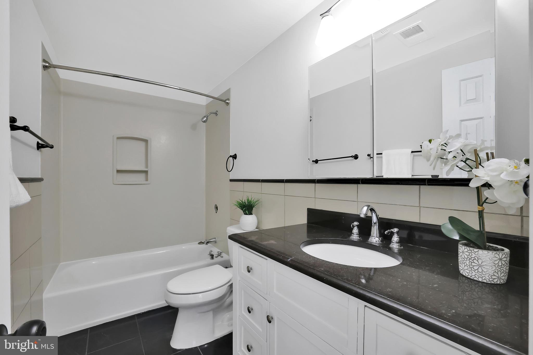 15101 Snowden Drive Silver Spring, MD 20905 - Photo 45 of 68 a bathroom with a granite countertop sink and a mirror
