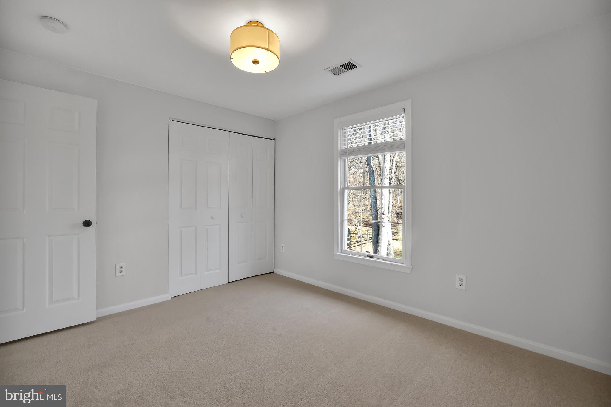 15101 Snowden Drive Silver Spring, MD 20905 - Photo 54 of 68 an empty room with windows and natural light
