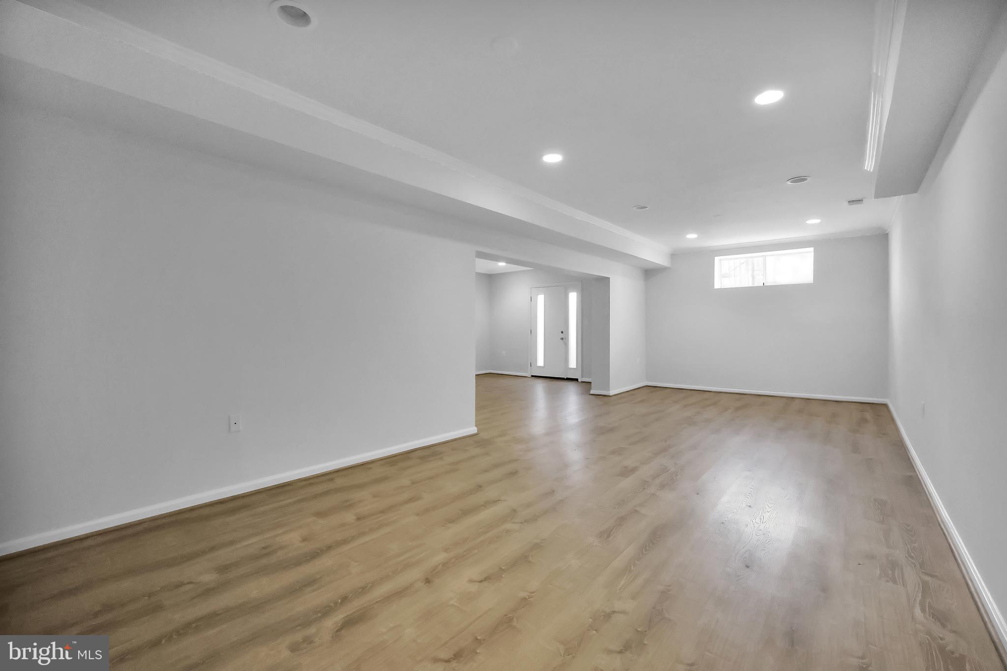 15101 Snowden Drive Silver Spring, MD 20905 - Photo 59 of 68 an empty room with wooden floor and windows