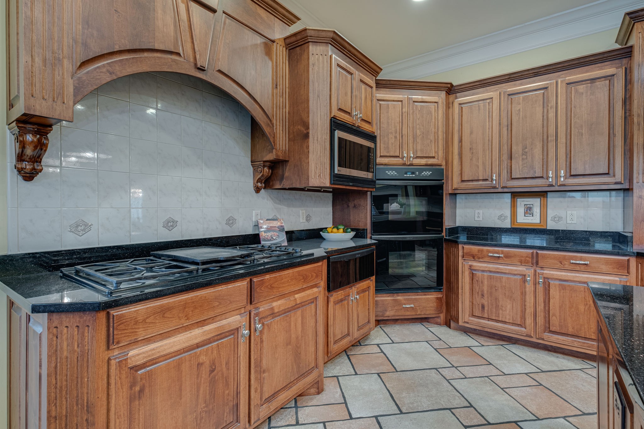 1727 Shagbark Trail Murfreesboro, TN 37130 - Photo 10 of 32 a kitchen with stainless steel appliances granite countertop a stove a sink and a microwave