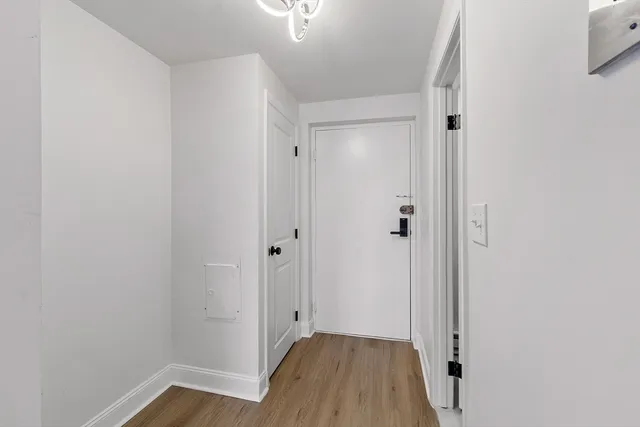 a view of a hallway with wooden floor