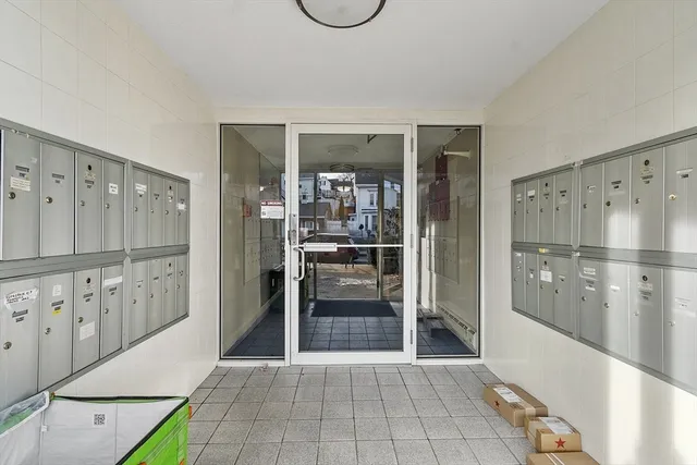 a view of a refrigerator in kitchen and an empty room