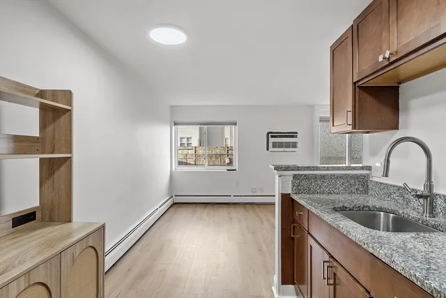 a kitchen with stainless steel appliances granite countertop a sink stove refrigerator and microwave