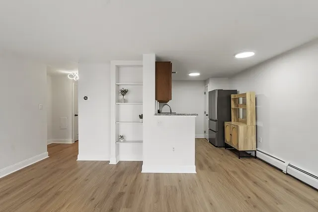 a view of kitchen with furniture and refrigerator
