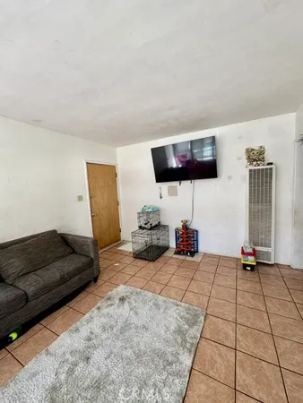 a view of a livingroom with furniture and a flat screen tv