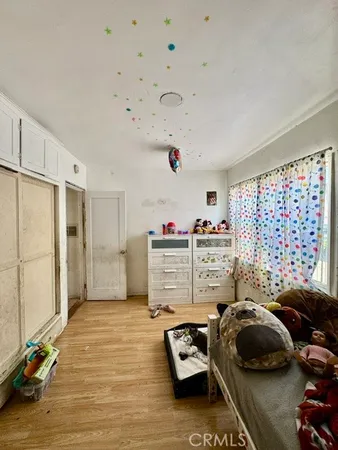 a bedroom with furniture and a window
