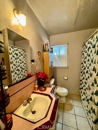 a bed sitting in a bedroom next to a larger window