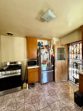 a kitchen with stainless steel appliances granite countertop a refrigerator and a stove