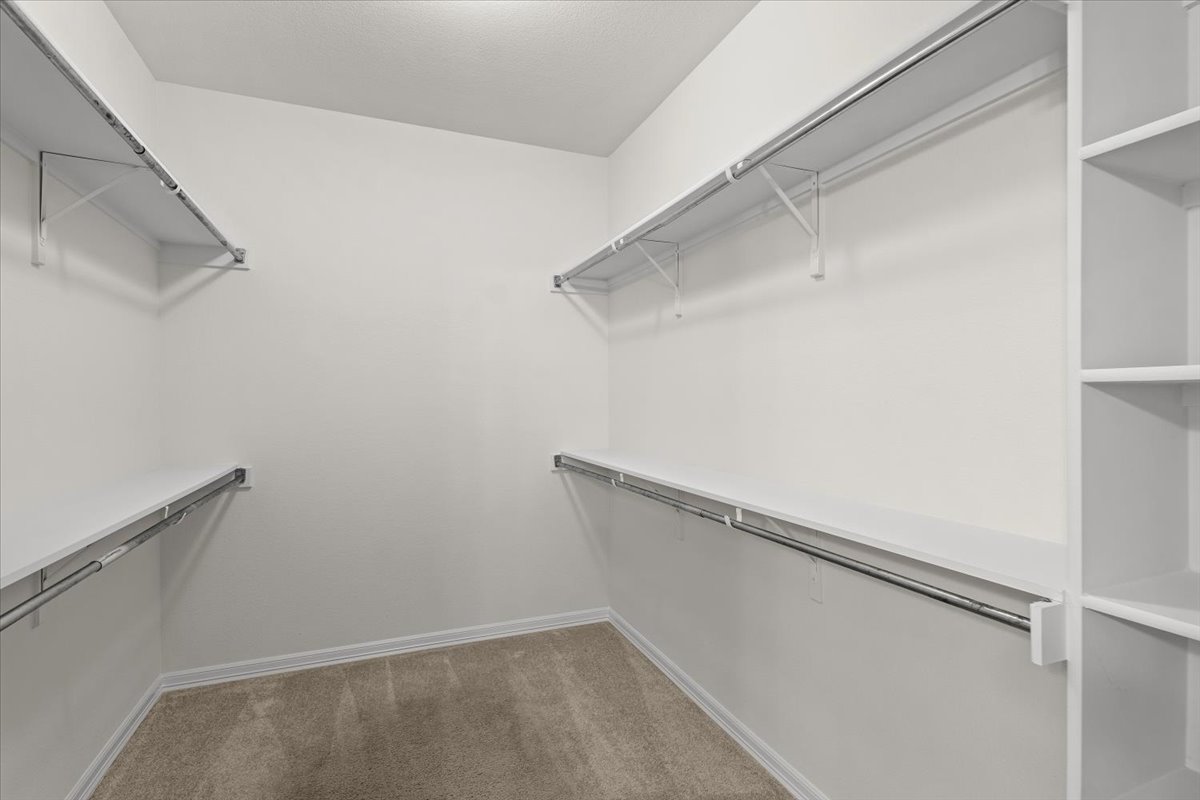 2304 Village View Loop Pflugerville, TX 78660 - Photo 30 of 40 Ample shelving and hanging space defines this generous walk-in closet, ready for personalized organization.