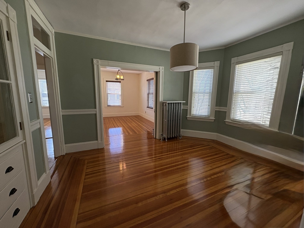 62 Ibbetson Street, Unit 3L Somerville, MA 02143 - Photo 1 of 20 a view of an empty room with window and wooden floor