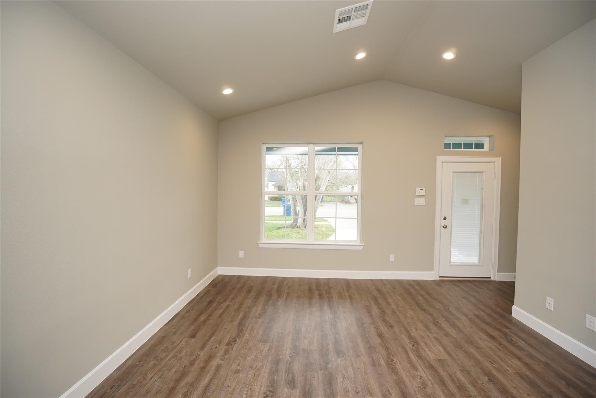 1137 4th Street Rosenberg, TX 77471 - Photo 6 of 16 an empty room with wooden floor and windows