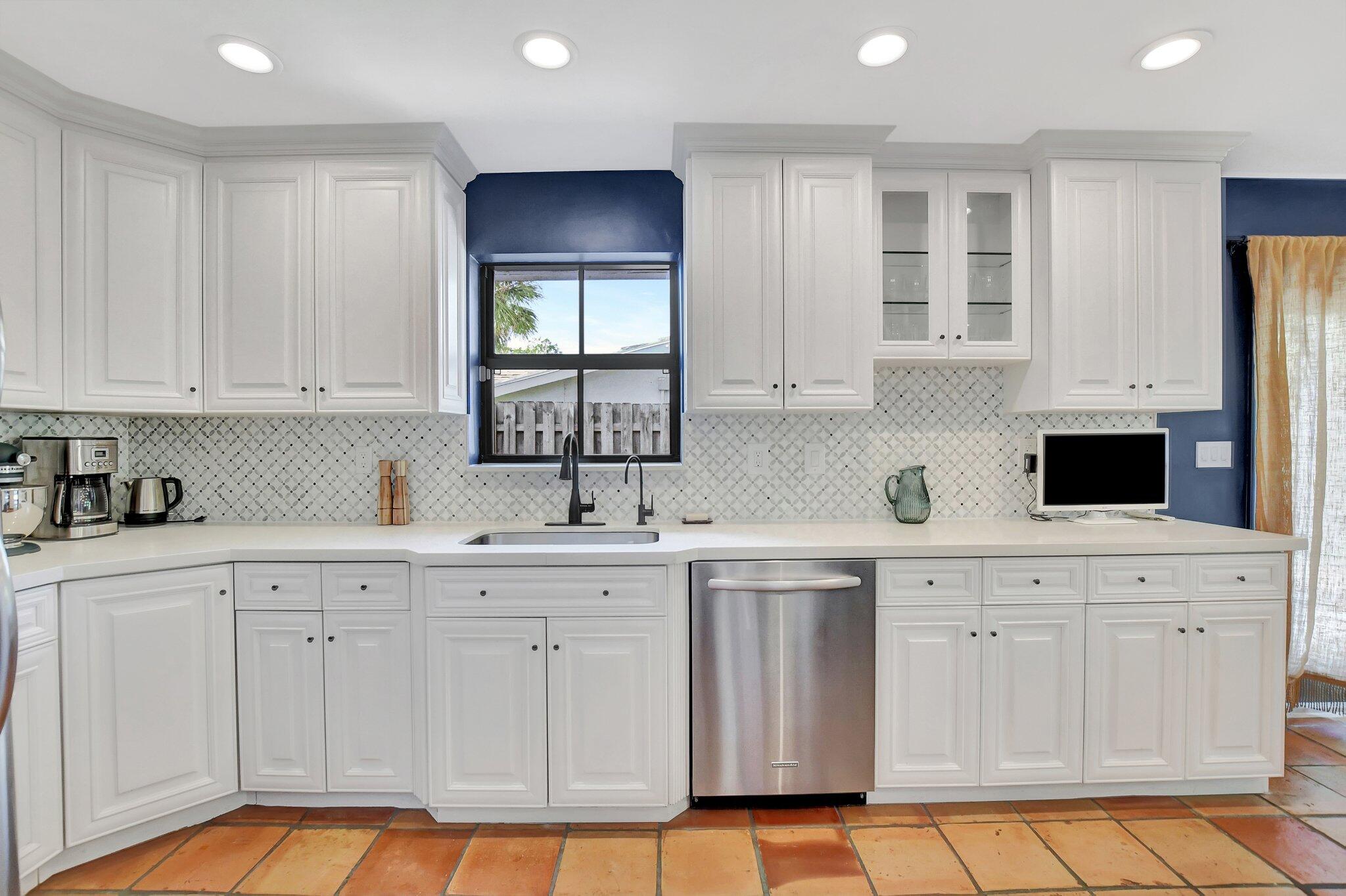 801 Southwest 5th Street Boca Raton, FL 33486 - Photo 12 of 50 a kitchen with white cabinets and sink