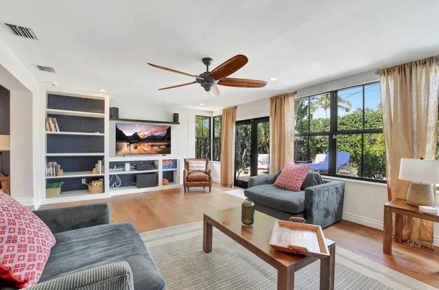 a living room with furniture and a large window with rug floor