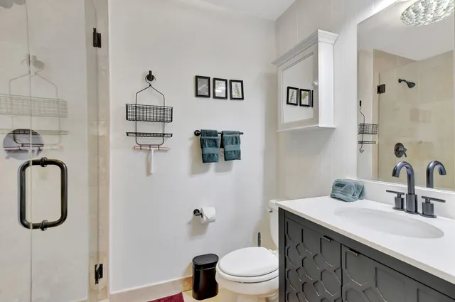 a bathroom with a sink toilet and shower