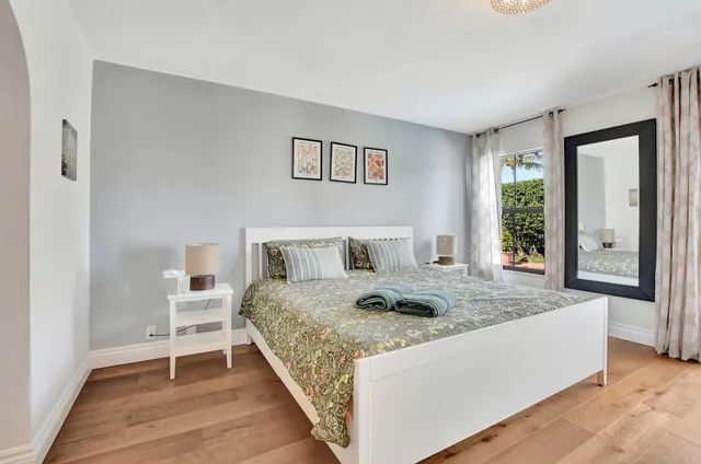 a room with a bed and a large window