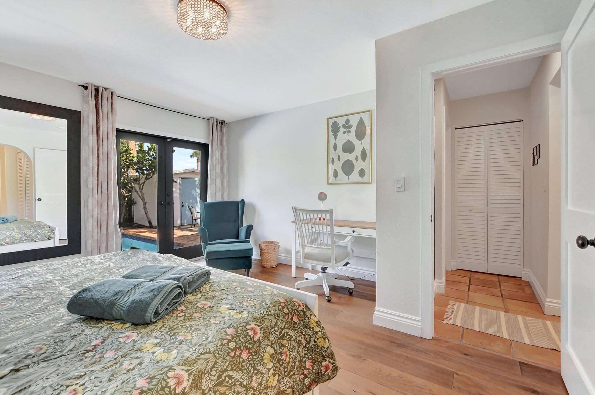 801 Southwest 5th Street Boca Raton, FL 33486 - Photo 30 of 50 a bedroom with a bed and wooden floor