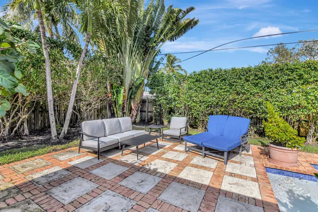 a view of a backyard with plants and a patio
