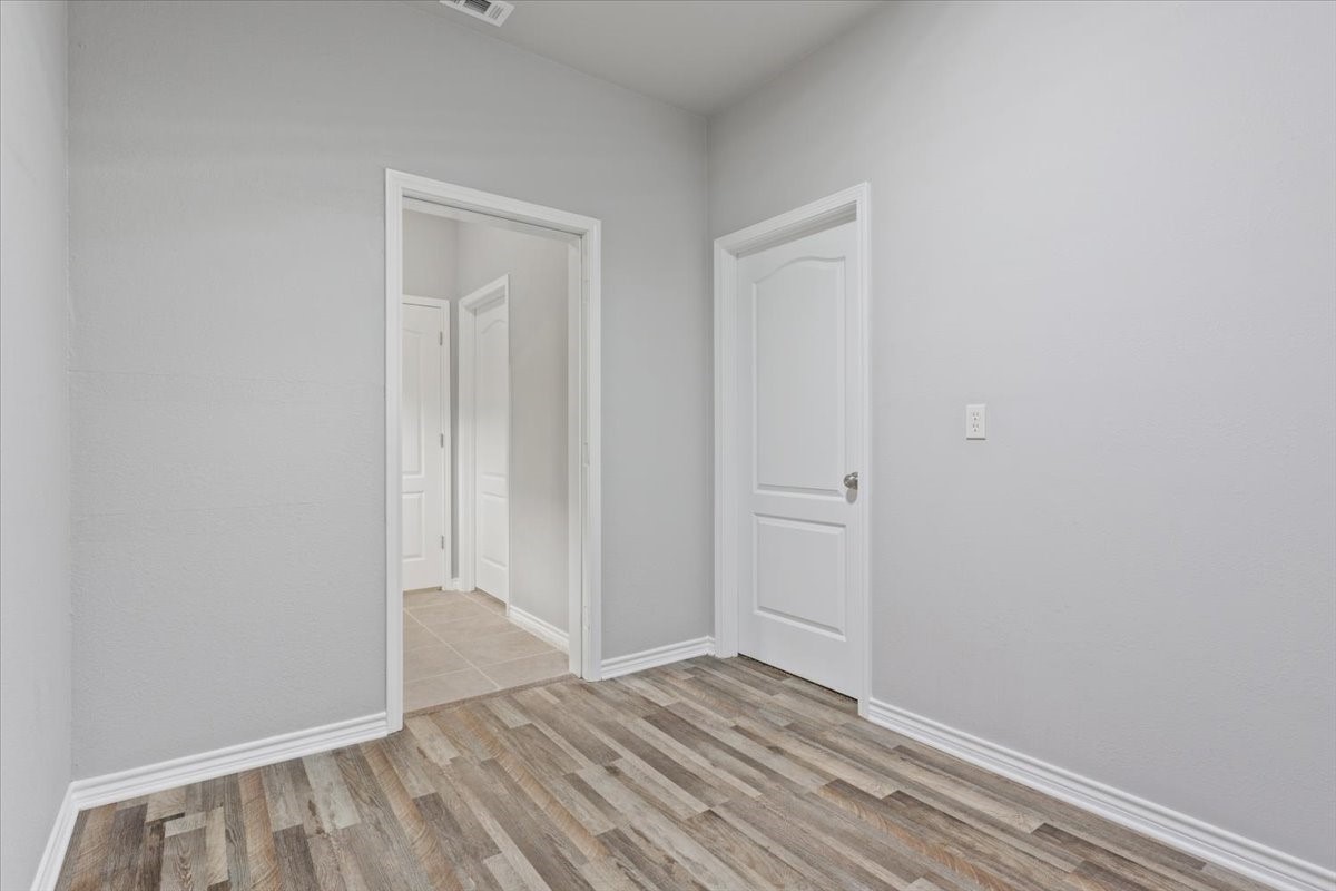 140 Oak Ridge Loop Whitney, TX 76692 - Photo 19 of 40 a view of an empty room with wooden floor