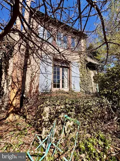 a view of a house with a yard covered in snow