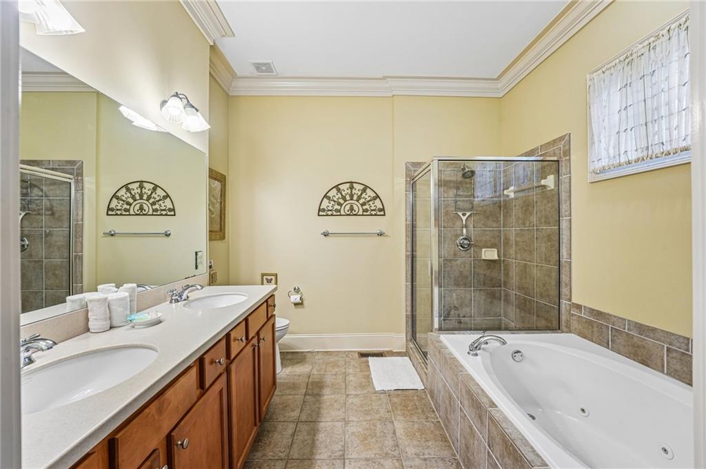 14 Laurel Ridge Lane Big Canoe, GA 30143 - Photo 28 of 72 a spacious bathroom with a granite countertop tub sink a mirror a shower and a bathtub