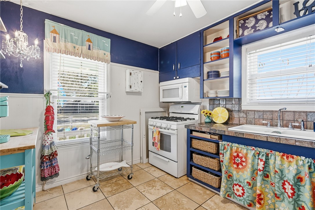 607 Chaparral Street Fulton, TX 78382 - Photo 12 of 40 a kitchen with stainless steel appliances a stove a sink and a refrigerator