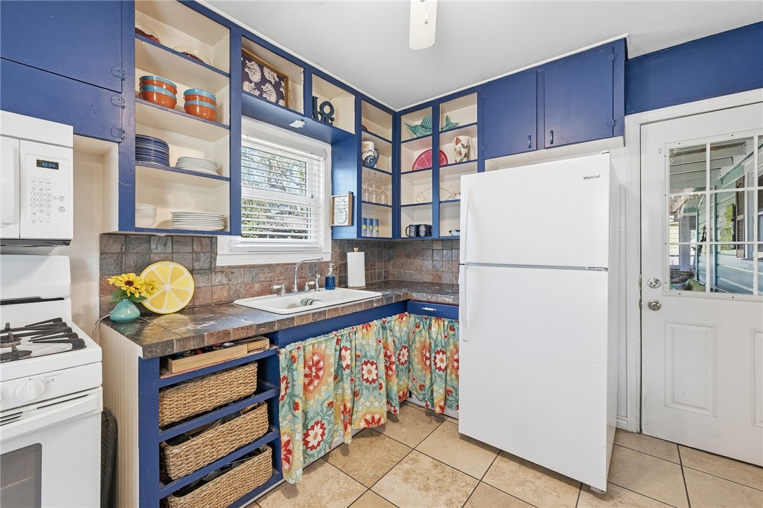607 Chaparral Street Fulton, TX 78382 - Photo 14 of 40 a kitchen with a refrigerator and a stove