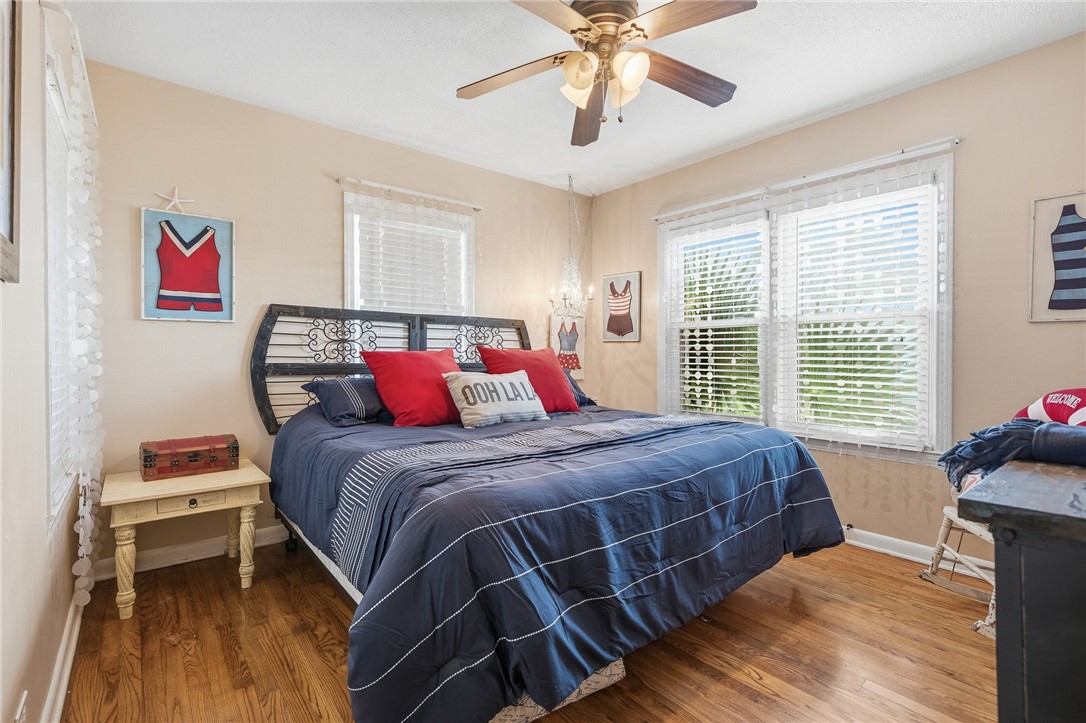 607 Chaparral Street Fulton, TX 78382 - Photo 19 of 40 a bedroom with a bed and wooden floor