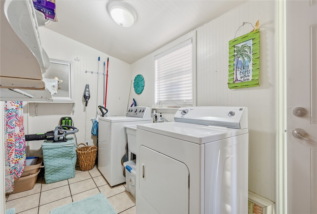 607 Chaparral Street Fulton, TX 78382 - Photo 21 of 40 a utility room with cabinets washer and dryer