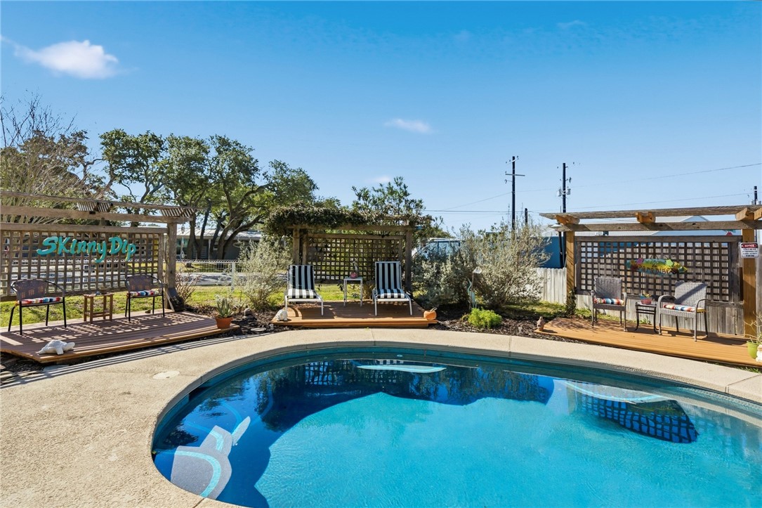 607 Chaparral Street Fulton, TX 78382 - Photo 27 of 40 a view of a swimming pool with a lounge chair