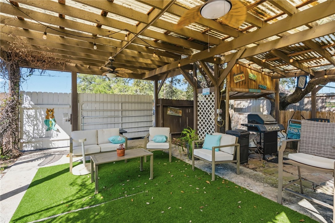 607 Chaparral Street Fulton, TX 78382 - Photo 30 of 40 a view of a chair and tables in the patio next to a yard