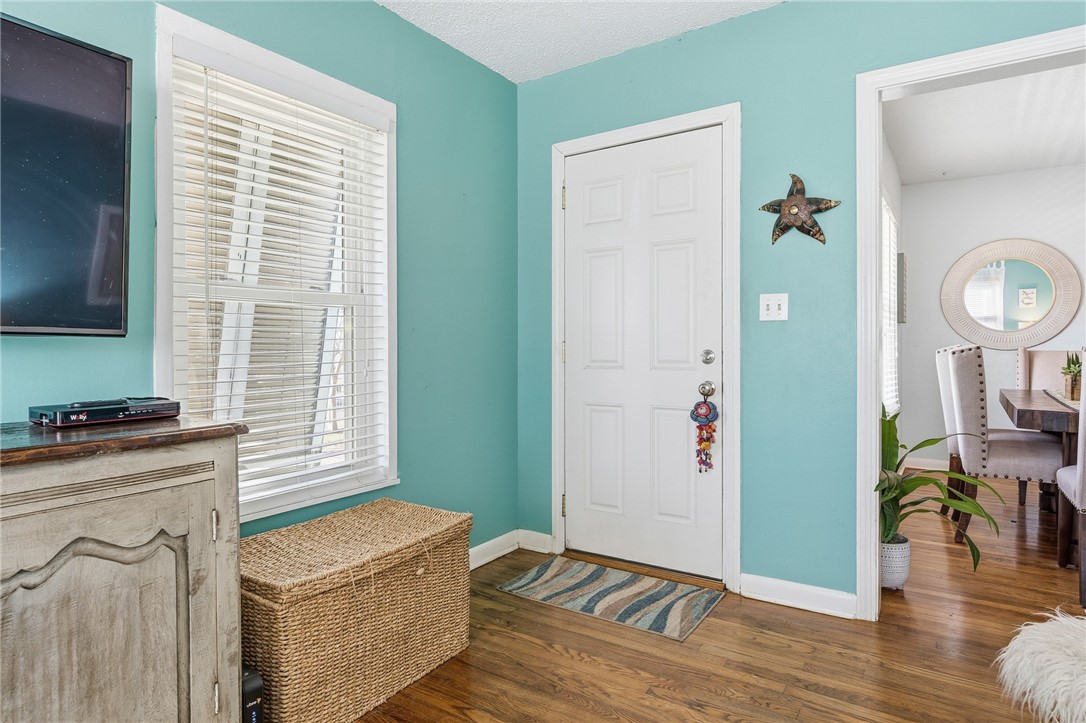607 Chaparral Street Fulton, TX 78382 - Photo 4 of 40 a view of a kitchen with fridge and wooden floor