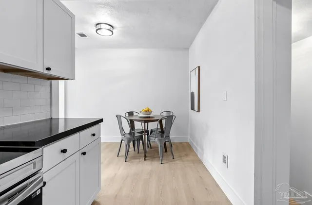 a dining room with furniture and wooden floor