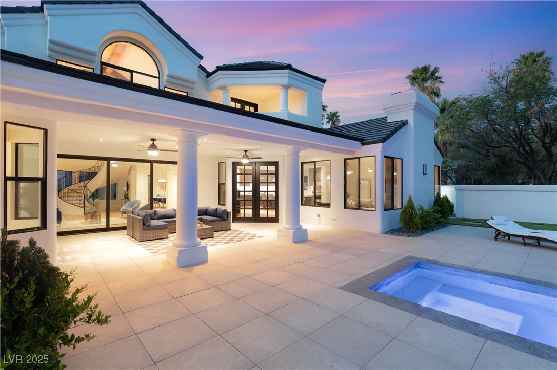 2316 Prometheus Court Henderson, NV 89074 - Photo 69 of 92 Back of property at dusk featuring a patio area, french doors, and stucco siding