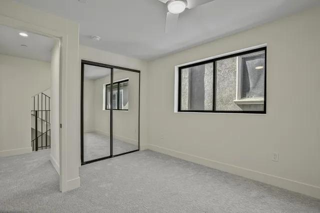 an empty room with windows and closet