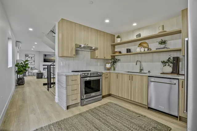 a kitchen with cabinets and wooden floor