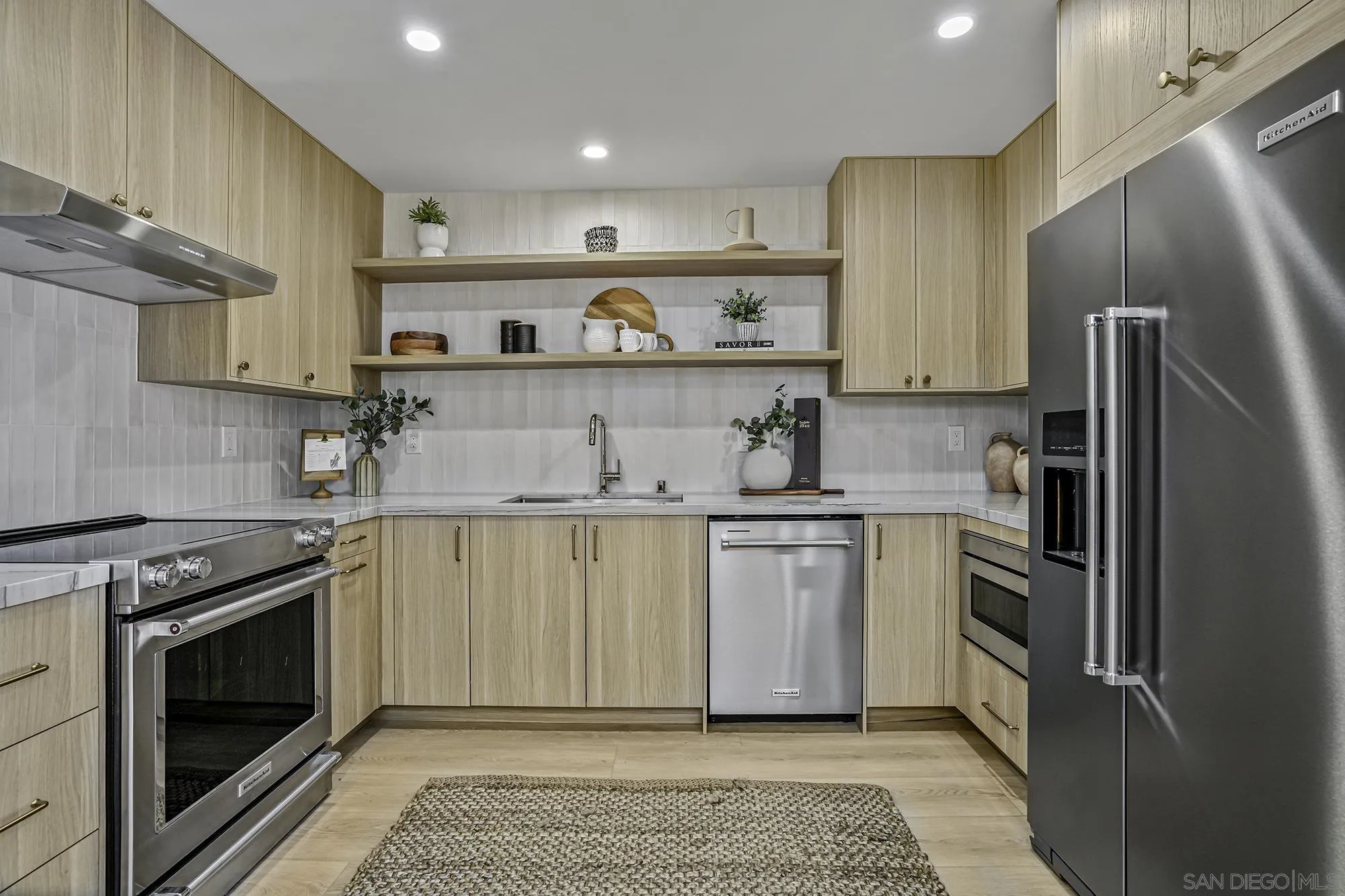 2124 San Clemente Street San Diego, CA 92107 - Photo 5 of 22 a kitchen with stainless steel appliances granite countertop a sink a stove a refrigerator and cabinets