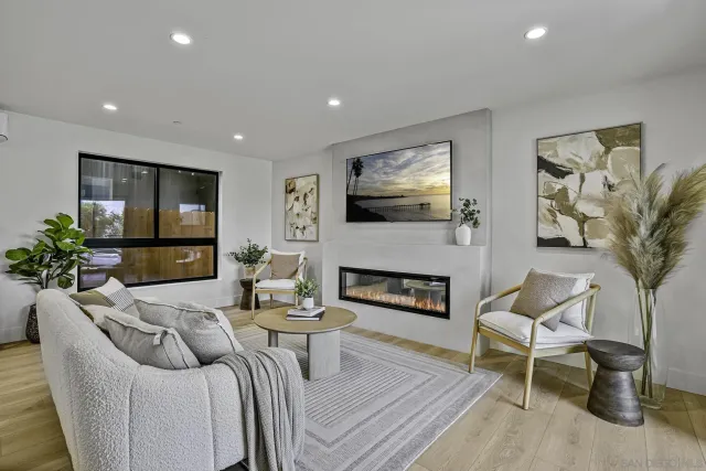 a living room with furniture a flat screen tv and a fireplace
