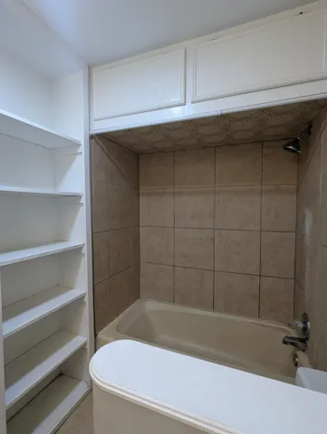a bathroom with a bathtub and a shower