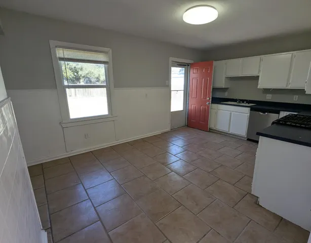 a kitchen with granite countertop a stove a sink and a granite counter top