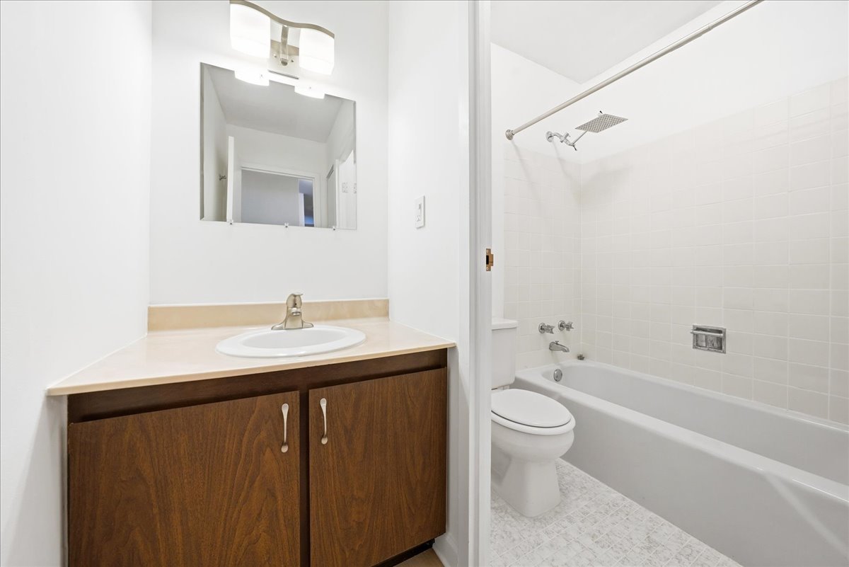 33 North Main Street, Unit 2E Lombard, IL 60148 - Photo 11 of 16 a bathroom with a sink a toilet and shower