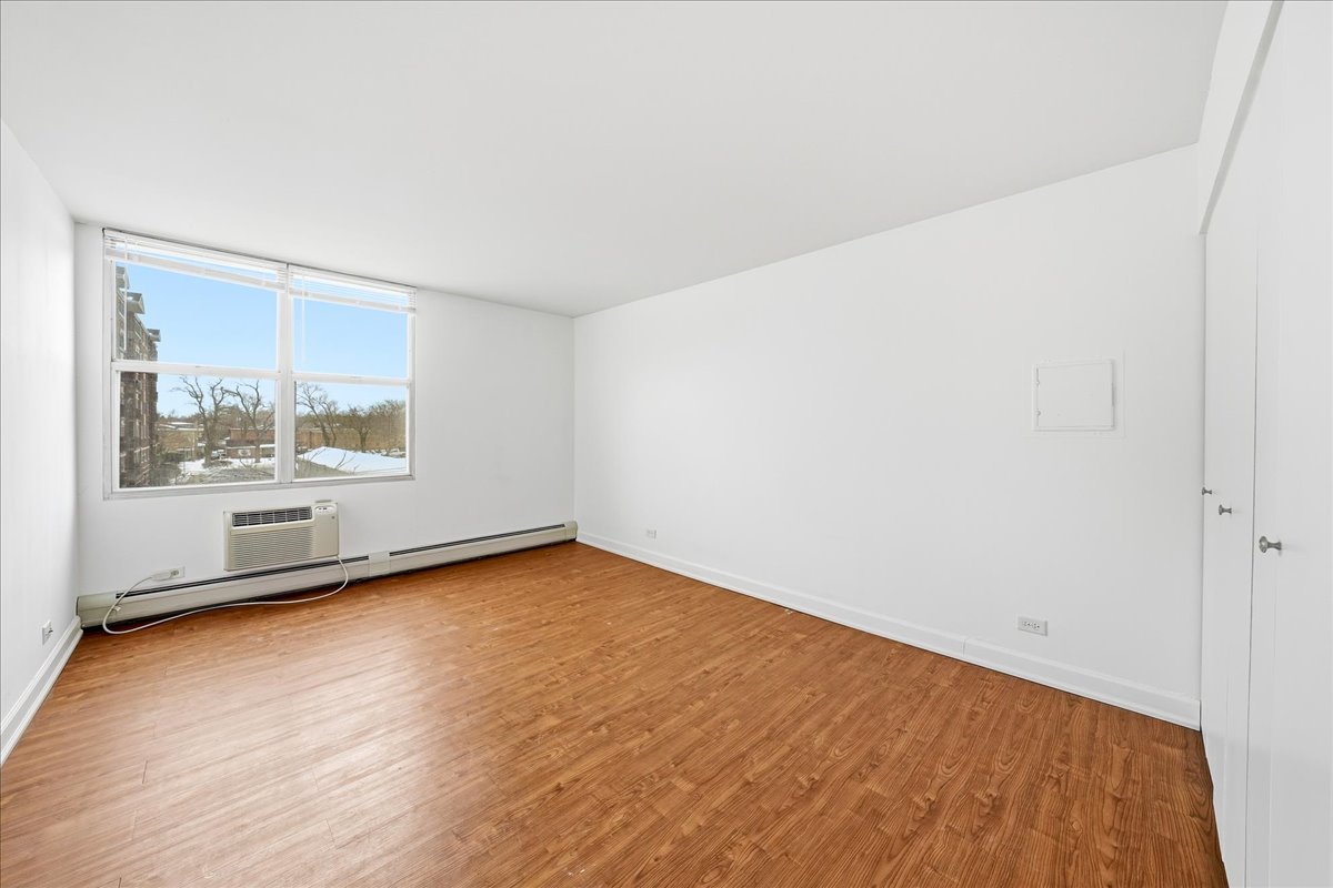33 North Main Street, Unit 2E Lombard, IL 60148 - Photo 13 of 16 an empty room with wooden floor and windows
