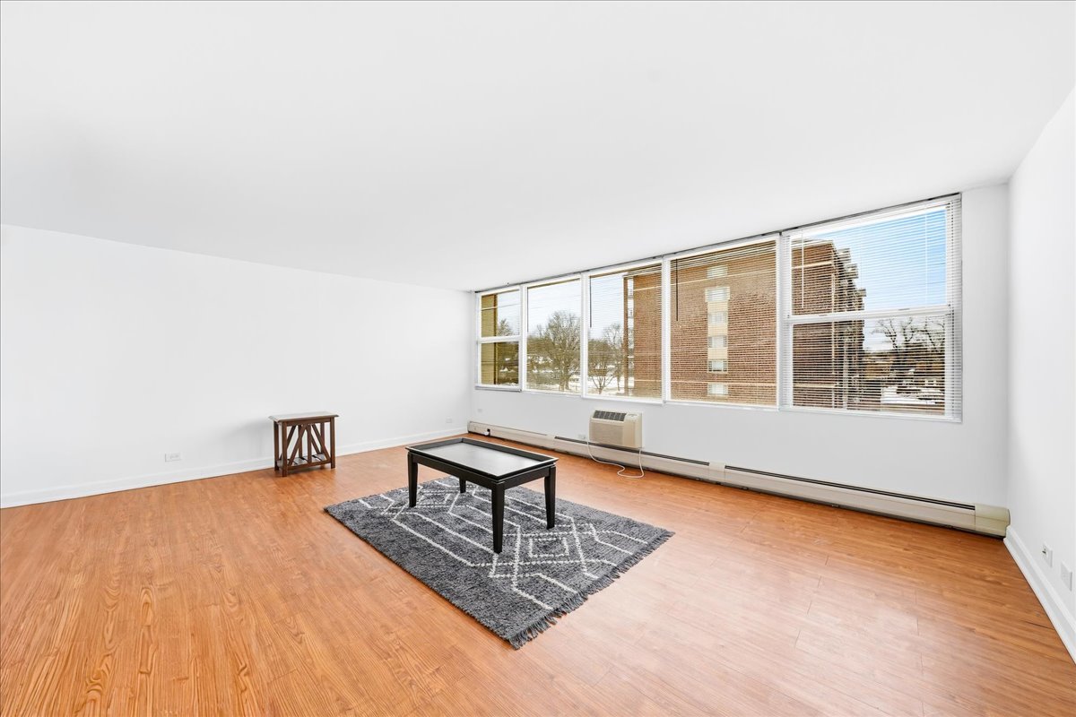 33 North Main Street, Unit 2E Lombard, IL 60148 - Photo 5 of 16 a living room with furniture wooden floor and a large window
