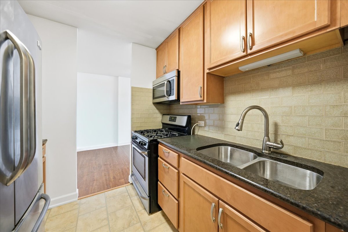 33 North Main Street, Unit 2E Lombard, IL 60148 - Photo 8 of 16 a close view of a sink and a refrigerator in a kitchen