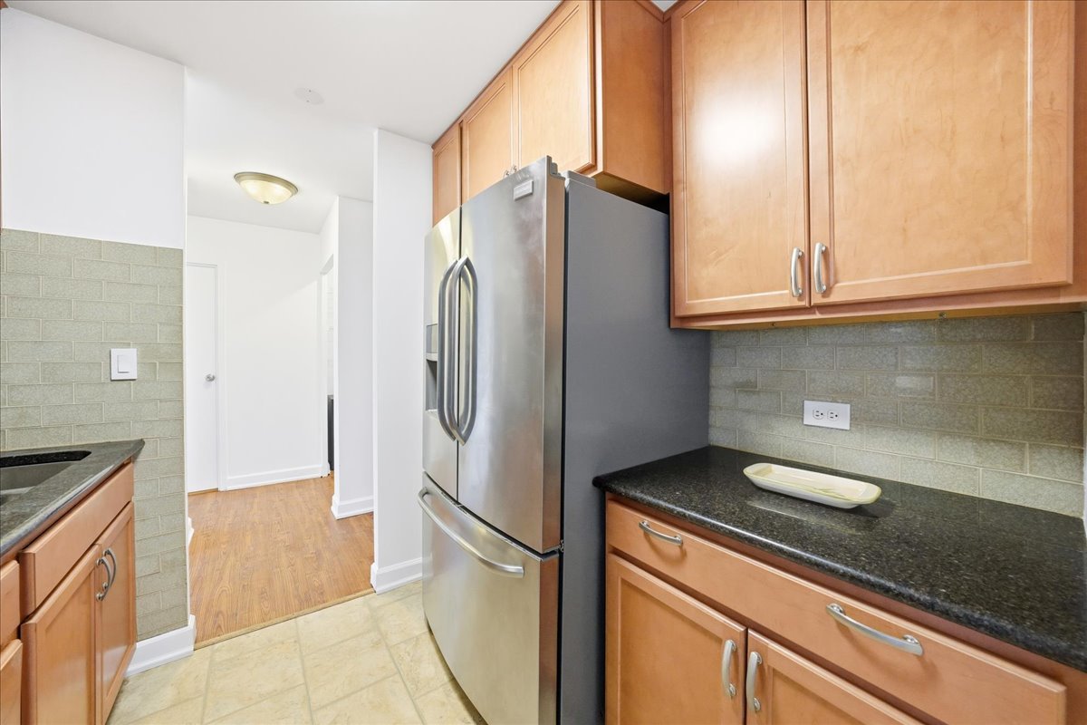 33 North Main Street, Unit 2E Lombard, IL 60148 - Photo 9 of 16 a kitchen with stainless steel appliances granite countertop a refrigerator and a stove