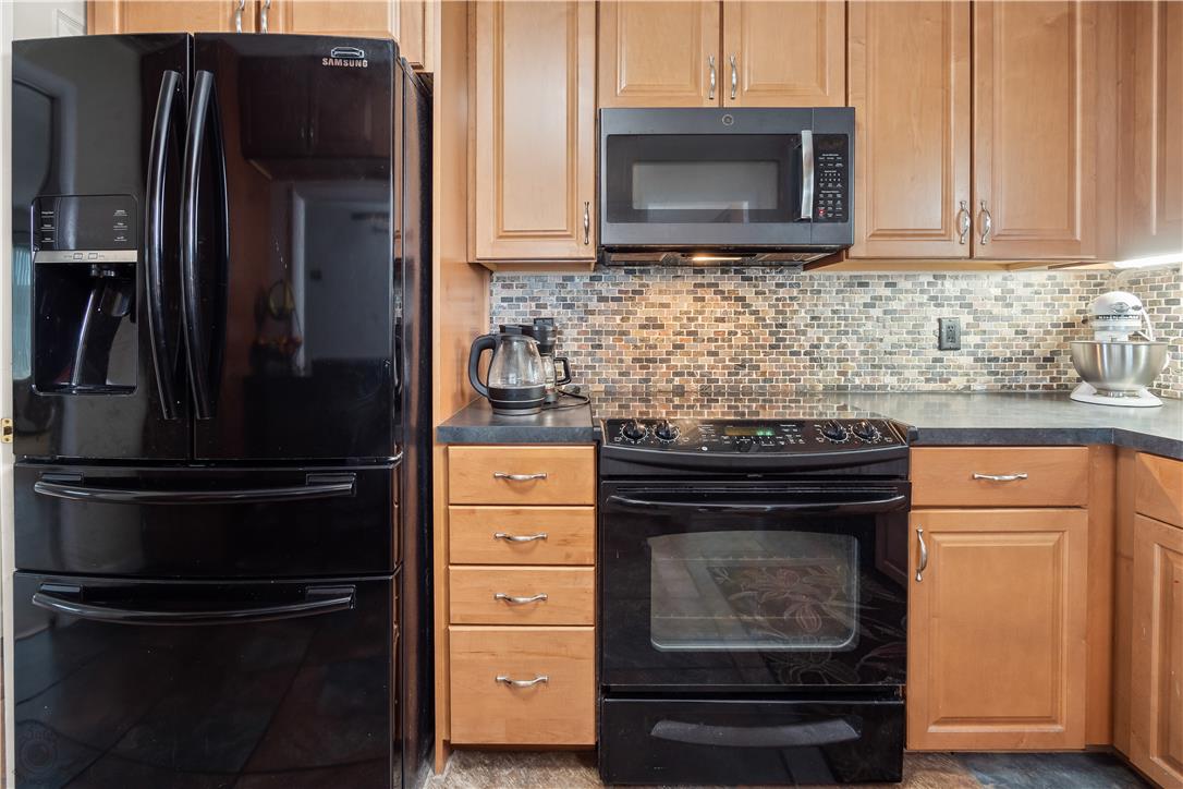 2439 Congress Street Allentown, PA 18104 - Photo 4 of 34 a kitchen with granite countertop a refrigerator stove and microwave