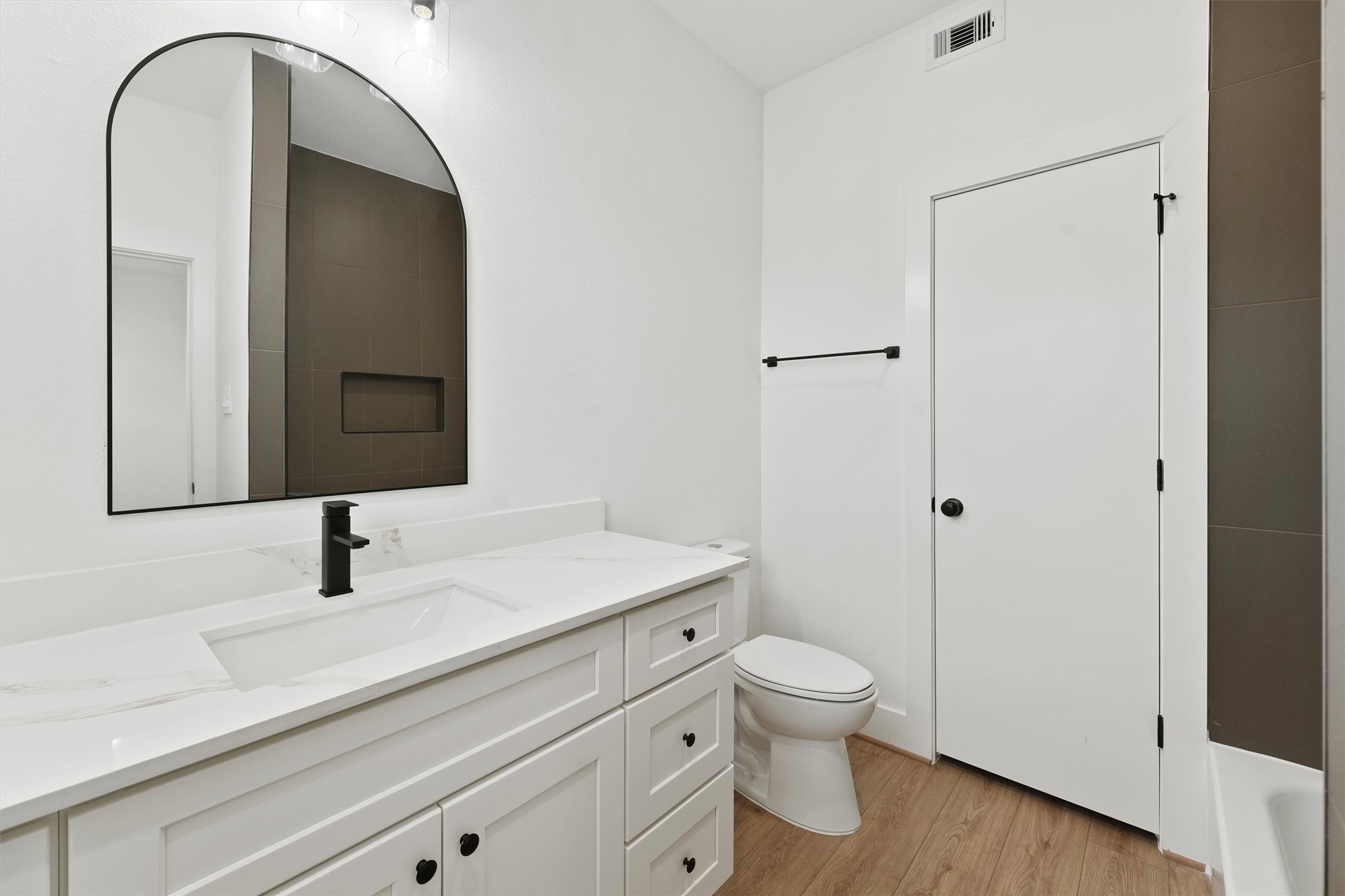 407 Calloway Street, Unit AB Houston, TX 77029 - Photo 9 of 19 a bathroom with a sink a toilet and a mirror