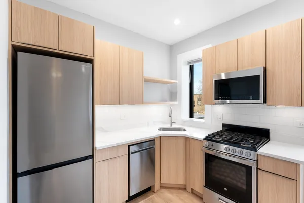 a kitchen with stainless steel appliances a refrigerator stove and microwave