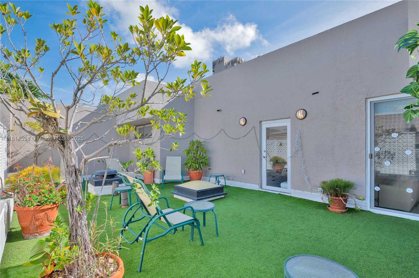 101 Crandon Boulevard, Unit 480 Key Biscayne, FL 33149 - Photo 13 of 28 a backyard of a house with table and chairs plants