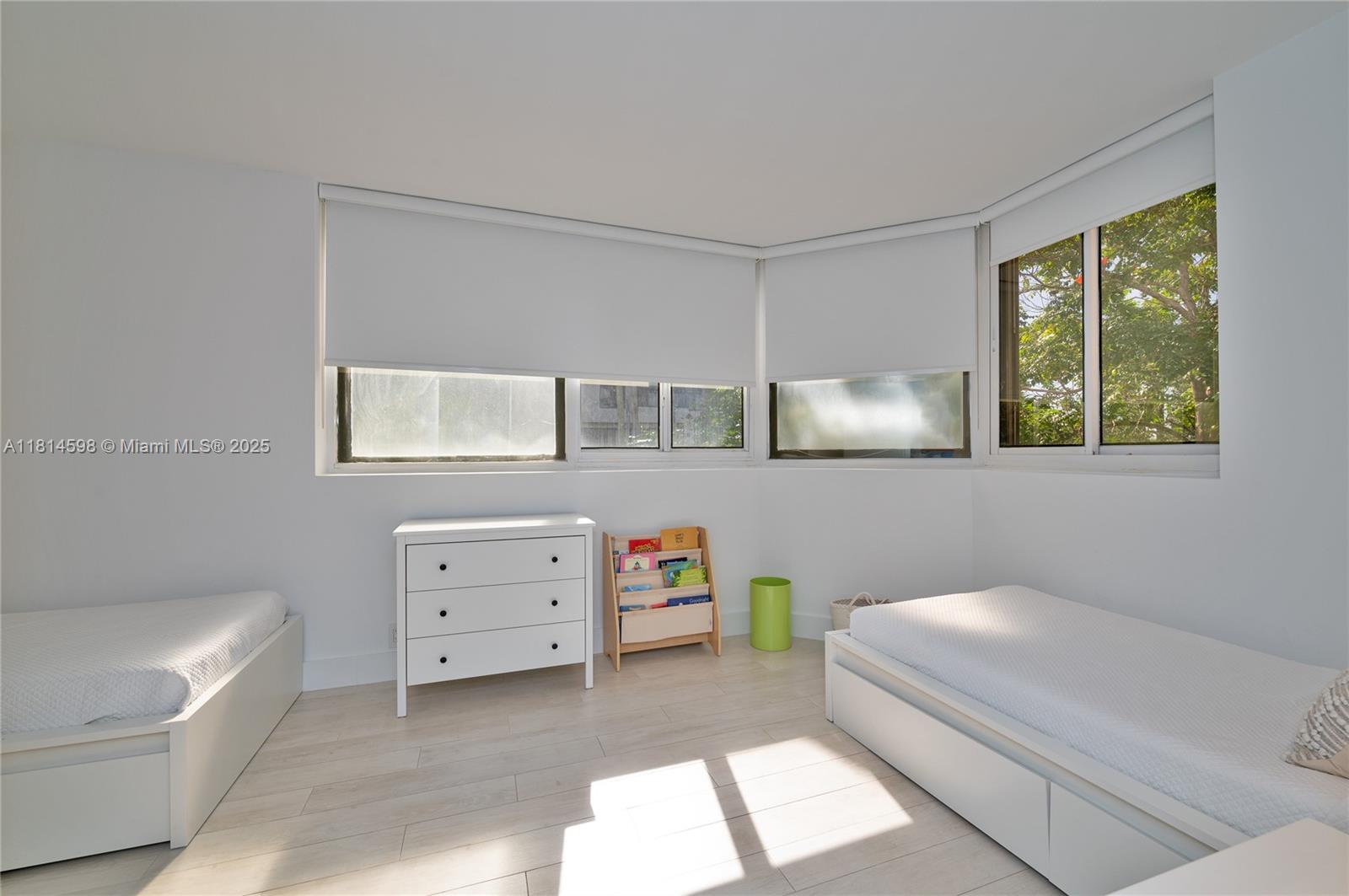 101 Crandon Boulevard, Unit 480 Key Biscayne, FL 33149 - Photo 23 of 28 a room with a baby bed baby crib and a dresser