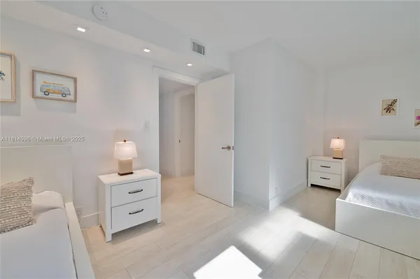 a spacious bedroom with a bed and a couch